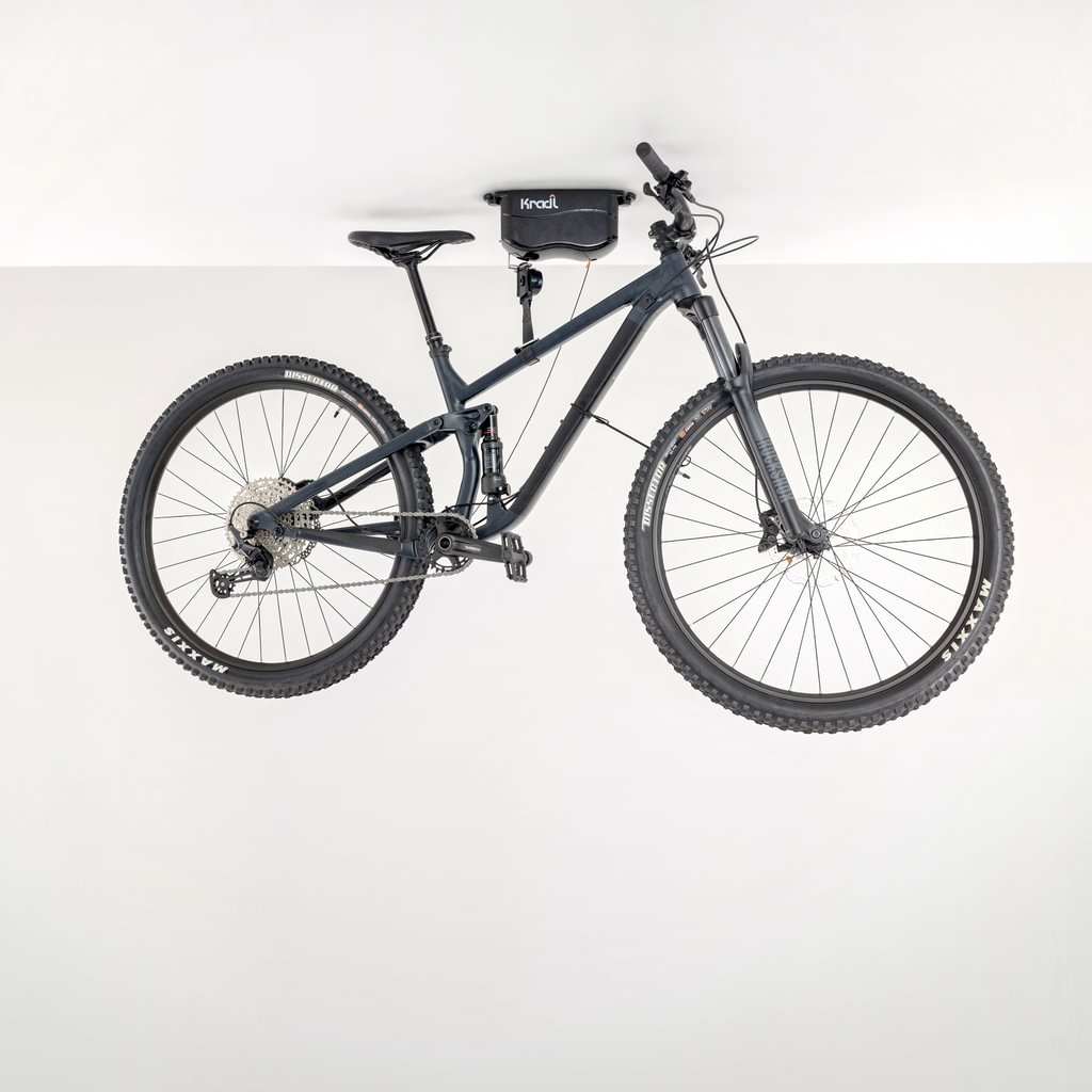 Black mountain bike hanging from Kradl