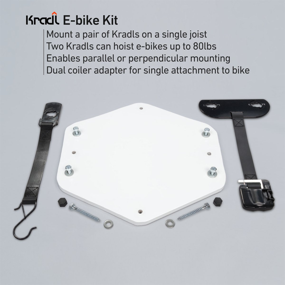 Kradl E-bike Kit components laid out on a light gray background, including a white hexagonal mounting plate, black straps, hardware, and text describing how to mount two Kradls to hoist e-bikes up to 80lbs.